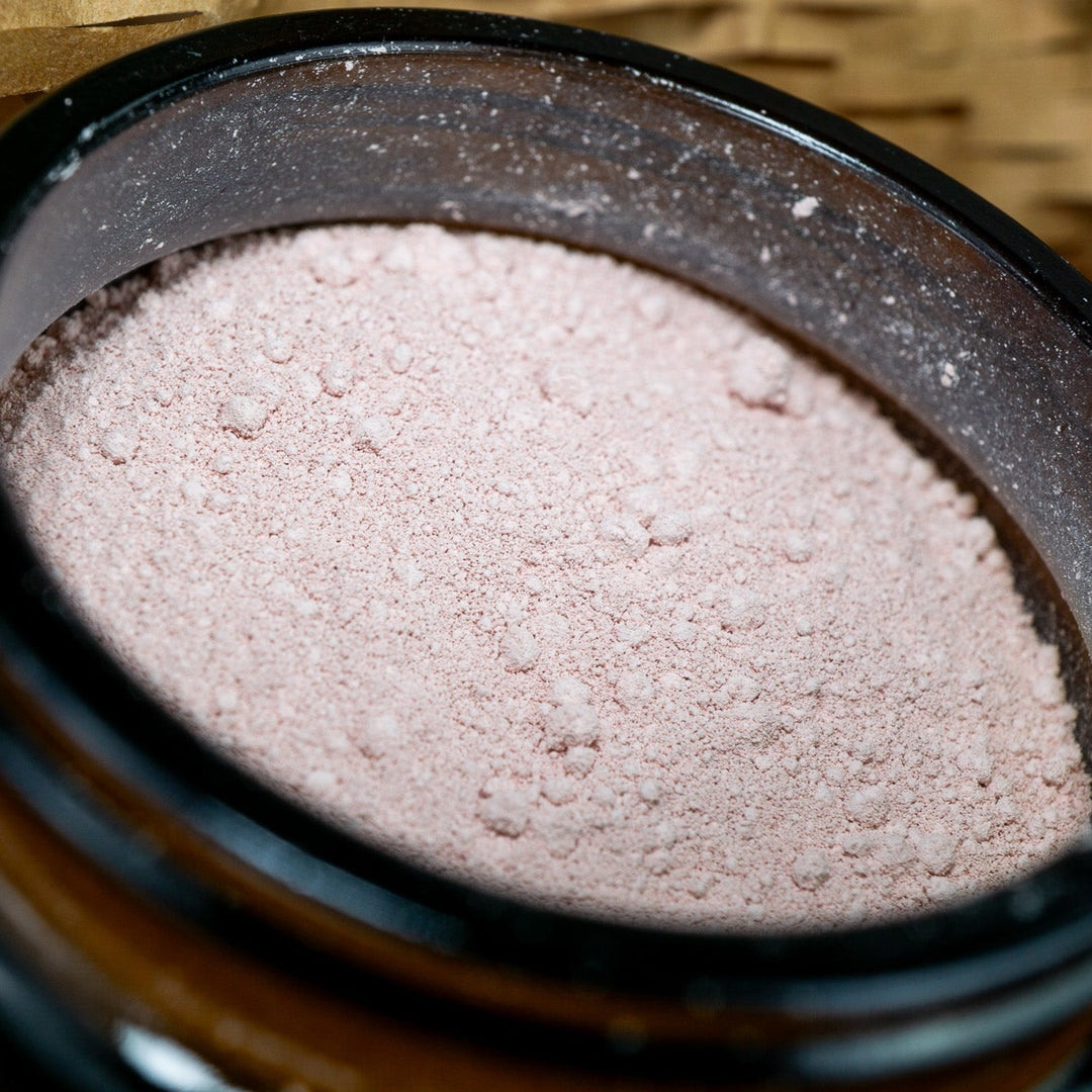 Close up of French pink clay in open jar