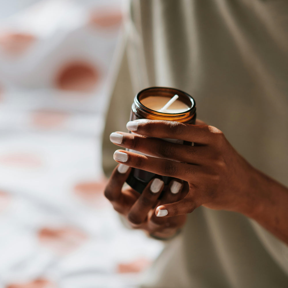 Candle in someones hand not lit